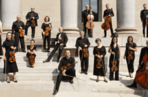 I Musici de Montréal - Chamber Orchestra standing on beige stairs