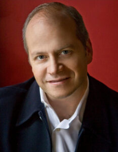 Portrait of Patrick Summers on red background